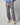 Trousers with a pattern of palm trees and geometric shapes on a white background